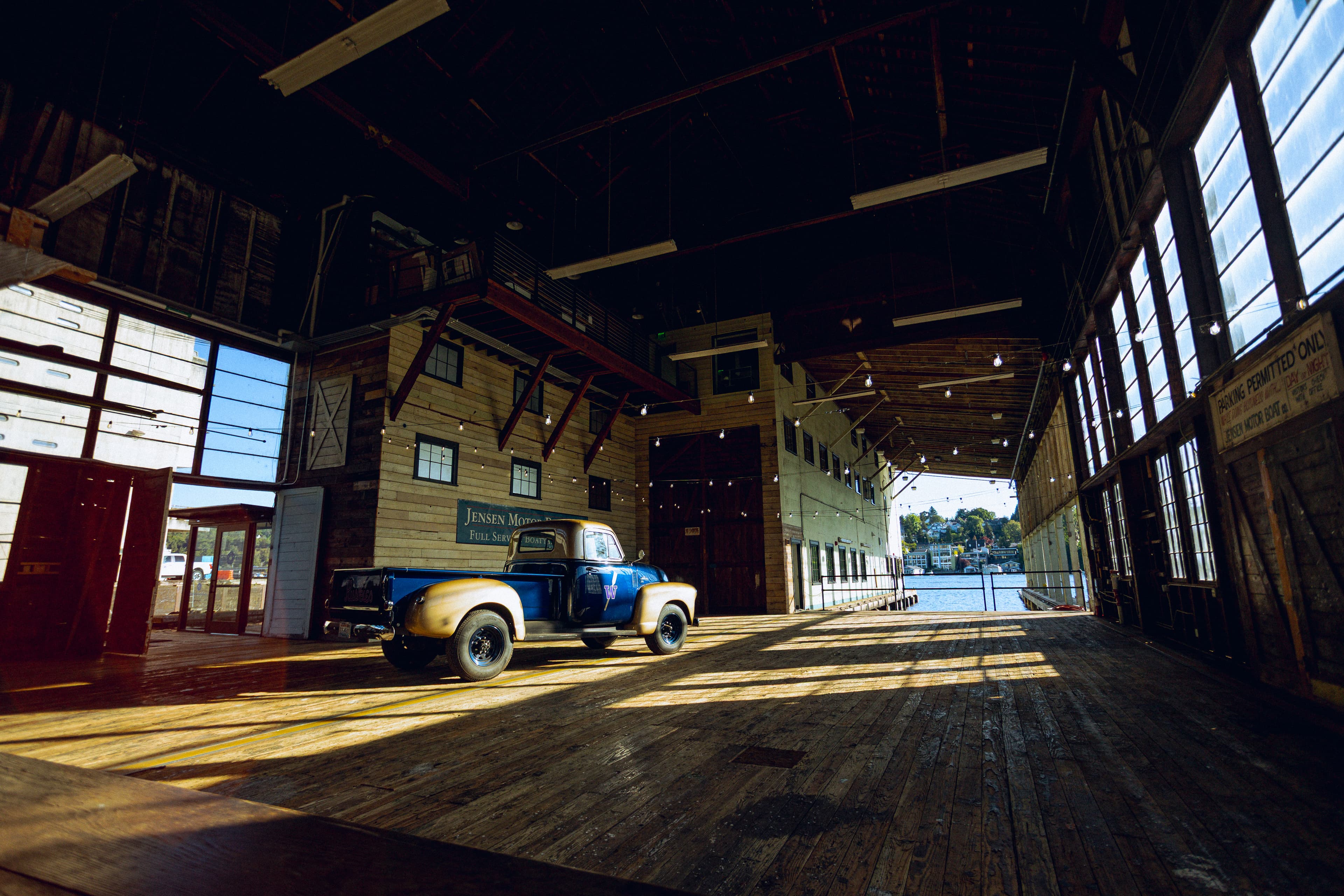 The historic boat barn at Seattle Paddle Club, with vintage truck on the timber deck